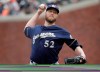 FILE - In this Saturday, June 15, 2019 file photo, Milwaukee Brewers pitcher Jimmy Nelson (52) throws to a San Francisco Giants batter during the second inning of a baseball game in San Francisco. Right-hander Jimmy Nelson and the Los Angeles Dodgers agreed Tuesday, Jan. 7, 2020 to a $1.25 million, one-year contract, an incentive-laden deal that could be worth $13.25 million over two seasons. In what's become a familiar refrain, the Dodgers arrive at camp still looking for their first World Series championship since 1988. After losing in two straight World Series, they were ousted by Washington in five games in the NL Division Series last fall. (AP Photo/Jeff Chiu, File)