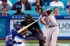 San Francisco Giants Buster Posey, right, hits a two-run home run as Los Angeles Dodgers catcher Will Smith, left, and home plate umpire Jeremie Rehak watch during the first inning of a baseball game Monday, July 19, 2021, in Los Angeles. (AP Photo/Mark J. Terrill)