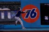 Milwaukee Brewers right fielder Ryan Braun leaps for but can't catch a line drive from Los Angeles Dodgers' Mookie Betts during the first inning in Game 1 of a National League wild-card baseball series Wednesday, Sept. 30, 2020, in Los Angeles. (AP Photo/Ashley Landis)