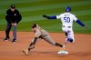 Los Angeles Dodgers' Mookie Betts (50) is forced out at second base by San Diego Padres second baseman Jake Cronenworth after a ground ball by Justin Turner during the first inning of a baseball game Thursday, April 22, 2021, in Los Angeles. (AP Photo/Marcio Jose Sanchez)