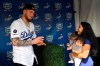 Los Angeles Dodgers' Alex Verdugo, left, gets ready to have his picture taken with Desirae Cortez, right, along with her children Emma, second from left, and Julianna during Dodger Stadium FanFest Saturday, Jan. 25, 2020, in Los Angeles. (AP Photo/Mark J. Terrill)