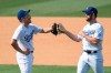 Los Angeles Dodgers first baseman Enrique Hernandez, left, and right fielder Adam Kolarek celebrate their win over the Los Angeles Angels in a baseball game in Los Angeles, Sunday, Sept. 27, 2020. (AP Photo/Kyusung Gong)