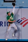 Oakland Athletics center fielder Mark Canha can't make the catch on a home run by Los Angeles Dodgers' A.J. Pollock during the fourth inning of a baseball game Tuesday, Sept. 22, 2020, in Los Angeles. (AP Photo/Ashley Landis)
