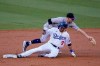 Los Angeles Dodgers' Gavin Lux (9) slides safely into second base with a double under Colorado Rockies shortstop Trevor Story during the second inning of a baseball game Saturday, Sept. 5, 2020, in Los Angeles. (AP Photo/Marcio Jose Sanchez)