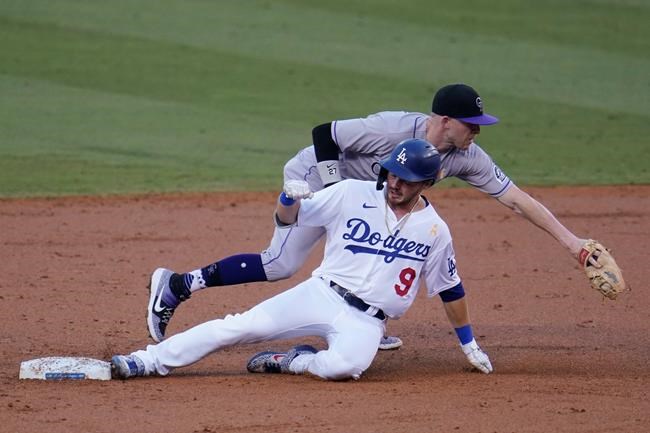 Los Angeles Dodgers' Gavin Lux (9) slides safely into second base with a double under Colorado Rockies shortstop Trevor Story during the second inning of a baseball game Saturday, Sept. 5, 2020, in Los Angeles. (AP Photo/Marcio Jose Sanchez)