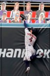 Houston Astros right fielder George Springer leaps but misses the ball for a two-run home run by Los Angeles Dodgers' Mookie Betts during the fifth inning of a baseball game in Los Angeles, Sunday, Sept. 13, 2020. (AP Photo/Alex Gallardo)