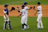 Los Angeles Dodgers catcher Austin Barnes, left, congratulates right fielder Mookie Betts, second from left, with shortstop Corey Seager, right, congratulating relief pitcher Blake Treinen, after the Dodgers defeat the Seattle Mariners, 2-1, in a baseball game in Los Angeles, Tuesday, Aug. 18, 2020. (AP Photo/Alex Gallardo)