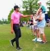 Tony Finau bumps fists with a young fan during the second round of the Zurich Classic golf tournament at TPC Louisiana in Avondale, La., Friday, April 23, 2021. (Max Becherer/The Times-Picayune/The New Orleans Advocate via AP)