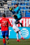 Costa Rica goalkeeper Esteban Alvarado, top, makes a save against United States forward Ulysses Llanez (19) during the first half of an international friendly soccer match in Carson, Calif., Saturday, Feb. 1, 2020. (AP Photo/Ringo H.W. Chiu)