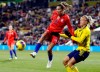 FILE - In this Thursday, Nov. 7, 2019 file photo, United States forward Tobin Heath, left, passes the ball in front of Sweden defender Hanna Glas during the first half of a women's international friendly soccer match in Columbus, Ohio. Tobin Heath will soon be hoping to play at Old Trafford again. The winger has more chance now she has signed for Manchester United, although the Women’s Super League team has yet to play in the stadium that has been home to the men’s side for 110 years. (AP Photo/Paul Vernon, File)