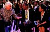 FILE - In this Dec. 15, 2013 file photo, British entrepreneur Richard Branson, left, speaks to South African billionaire Patrice Motsepe, centre, and his wife Precious Makgosi Moloi, right, before the funeral service for former South African President Nelson Mandela in Qunu, South Africa. South African businessman Patrice Motsepe entered the race to be president of the African soccer confederation on Monday Nov. 9, 2020. (AP Photo/Felix Dlangamandla, Pool, File)