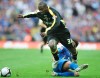 FILE - In this May 17, 2008 file photo, Portsmouth's Glen Johnson, rear, challenges Cardiff City's Jimmy Floyd Hasselbaink during the English FA Cup final soccer match at Wembley Stadium, London. Former Chelsea and Netherlands striker Jimmy Floyd Hasselbaink has been reappointed as manager of relegation-threatened Burton Albion in England's third division. (AP Photo/Tom Hevezi, File)