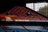 FILE - In this Monday, Sept. 21, 2020 file photo, the sun illuminates the empty stands before the English Premier League soccer match between Aston Villa and Sheffield United at the Villa Park stadium in Birmingham, England. Every empty seat in a Premier League stadium represents a visual reminder of the financial struggle many soccer teams are facing amid the coronavirus pandemic. For smaller soccer teams without TV contracts and huge fan bases, empty seats at matches amid the pandemic can have devastating financial implications. (Tim Goode/Pool via AP, File)