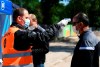 An employee measures the temperature of a person entering the stadium before the 2nd Bundesliga soccer match between Karlsruher SC - SV Darmstadt 98, in the Wildpark Stadium, Karlsruhe, Germany, Saturday May 16, 2020. The German Bundesliga becomes the world's first major soccer league to resume after a two-month suspension because of the coronavirus pandemic. (Matthias Hangst/Pool via AP)