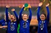 Chelsea's Sam Kerr, left, Erin Cuthbert and Melanie Leupolz, right, celebrate with the trophy after winning the FA Women's League Cup final soccer match against Bristol City at Vicarage Road, London, Sunday March 14, 2021. (Mike Egerton/PA via AP)