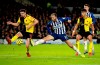 Watford's Craig Cathcart and Brighton and Hove Albion's Glenn Murray, center, battle for the ball during the English Premier League soccer match at the AMEX Stadium, Brighton, England, Saturday Feb. 8, 2020. (Adam Davy/PA via AP)