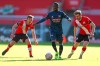 Arsenal's Nicolas Pepe, center, battles for the ball with Southampton's James Ward-Prowse, left, and Stuart Armstrong during the Emirates FA Cup fourth round soccer match at St. Mary's Stadium, Southampton, England, Saturday Jan. 23, 2021. (Catherine Ivill/PA via AP)