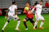 Lille's French midfielder Benjamin Andre, center, is challenged by Lyon's French midfielder Houssem Aouar, right, during the French League One soccer match between Lille and Olympique Lyonnais at the Pierre-Mauroy Stadium in Villeneuve d'Ascq, northern France, Sunday, Nov. 1, 2020. (Francois Lo Presti, Pool via AP)