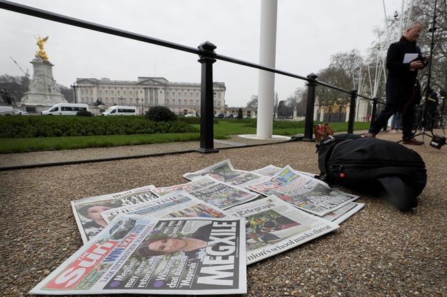 Newspapers are placed on the ground placed by a television crew in front of Buckingham Palace in London, Monday, March 8, 2021. Britain's royal family is absorbing the tremors from a sensational television interview by Prince Harry and the Duchess of Sussex, in which the couple said they encountered racist attitudes and a lack of support that drove Meghan to thoughts of suicide. (AP Photo/Kirsty Wigglesworth)