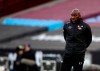 FILE - In this Saturday, Jan. 23, 2021 file photo, Darren Moore looks on during the English FA Cup fourth round soccer match between West Ham United and Doncaster Rovers at the London Stadium in London. Sheffield Wednesday manager Darren Moore says he has developed pneumonia and blood clots on his lungs following a recent coronavirus infection. The 46-year-old Moore returned from the requisite COVID-19 isolation period on Monday, April 12 but felt discomfort the next night following the Owls’ 2-0 loss to Swansea. (AP Photo/Ian Walton, file)