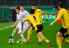 Moenchengladbach's Jonas Hofmann, left, and Dortmund's Mahmoud Dahoud fight for the ball during the German Soccer Cup quarter final match between Borussia Moenchengladbach and Borussia Dortmund at Borussia Park, Moenchengladbach, Germany, Tuesday, March 2, 2021. (Federico Gambarini/Pool photo via AP)