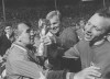 FILE - In this July 30, 1966 file photo, England midfield player Nobby Stiles, right, looks at the Jules Rimet Cup, held by England captain Bobby Moore after they had won the World Cup Final at Wembley, London. Stiles, a tenacious midfielder who won the World Cup with England in 1966 and the European Cup with Manchester United in 1968, has died. He was 78. Stiles' family said Friday, Oct. 30, 2020 that he died following a long illness. (AP Photo, file)