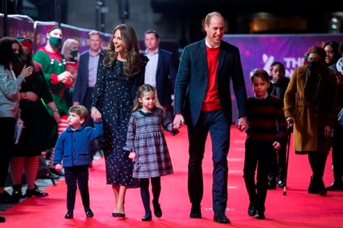 FILE - In this Friday Dec. 11, 2020 file photo, Britain's Prince William and Kate, The Duke and Duchess of Cambridge and their children, Prince Louis, left, Princess Charlotte and Prince George arrive for a special pantomime performance at London's Palladium Theatre. One of the most dramatic claims in Prince Harry and Meghan's interview with Oprah Winfrey was that their son was denied a royal title, possibly because of the color of his skin. Queen Elizabeth II has nine great-grandchildren, including Archie. They are not princes and princesses, apart from the three children of Prince William, who is second in line to the throne and destined to be king one day. (Aaron Chown/Pool via AP, file)