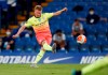 FILE - In this Thursday, June 25, 2020 file photo, Manchester City's Kevin De Bruyne scores a goal from a free kick during their English Premier League soccer match against Chelsea at Stamford Bridge, in London, England. Likely to be up there as the biggest challengers to Liverpool, Pep Guardiola’s side can blow any team off the park when they are on form but the Spaniard needs to make sure there are not as many off days for his side in the coming months. (Paul Childs/Pool Photo via AP, file)