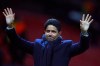 FILE - In this Tuesday, Feb. 12, 2019 file photo, Paris Saint Germain owner Nasser bin Ghanim Al-Khelaifi waves to teams fans at the end of their soccer match against Manchester United at Old Trafford stadium in Manchester, England. Qatari soccer and television executive Nasser al-Khelaifi will go on trial starting Sept. 14, 2020 in Switzerland in September, implicated in providing a holiday villa to a FIFA official linked to a World Cup broadcasting deal. The court has listed 10 days in September to hear the case against al-Khelaifi, former top FIFA official Jerome Valcke and another broadcasting executive who was not identified. (AP Photo/Dave Thompson, file)