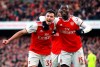 Arsenal's Gabriel Martinelli, left, celebrates scoring his sides first goal of the game with teammate Nicolas Pepe during the English Premier League soccer match between Arsenal and Sheffield United at the Emirates Stadium, London, Saturday, Jan. 18, 2020. (Adam Davy/PA via AP)