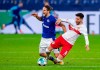 Stuttgart's Atakan Karazor, right, and Schalke's Goncalo Paciencia fight for the ball during the German Bundesliga soccer match between Schalke 04 and Stuttgart at the Veltins Arena in Gelsenkirchen, Germany, Friday, Oct. 30, 2020. (Guido Kirchner/dpa via AP)