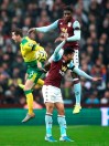 Norwich City's Kenny McLean, left, battles for the ball with Aston Villa's Kortney Hause, top, and Trezeguet during their English Premier League soccer match at Villa Park, Birmingham, England, Thursday, Dec. 26, 2019. (Nick Potts/PA via AP)