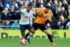 Tottenham Hotspur's Steven Bergwijn, left, and Wolverhampton Wanderers' Ruben Neves battle for the ball during the English Premier League soccer match between Tottenham and Wolverhampton Wanderers at the Tottenham Hotspur Stadium, London, Sunday, March 1, 2020. (Bradley Collyer/PA via AP)