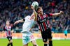Union's Marius Bulter, left, and Frankfurt's David Abraham fight for the ball during the German Bundesliga soccer match between Eintracht Frankfurt and 1 FC Union Berlin, at the Commerzbank Arena in Frankfurt, Germany, Monday, Feb. 24, 2020. (Uwe Anspach/dpa via AP)