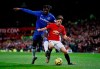 Everton's Moise Kean, left, and Manchester United's Daniel James battle for the ball during the English Premier League match between Manchester United and Everton at Old Trafford, Manchester, England, Sunday, Dec. 15, 2019. (Martin Rickett/PA via AP)