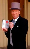 FILE - In this April 27, 2005 file photo, Former Manchester CIty footballer Colin Bell poses for media with his MBE in London. Colin Bell, one of the finest English midfielders of his generation and greatest players to have appeared for Manchester City, has died, it was announced Tuesday, Jan. 15, 2021. He was 74. His name lives on in the “Colin Bell Stand” named after him at the Etihad Stadium.(Fiona Hanson/PA via AP, file)