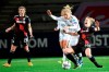 Bayern's Carolin Simon, center, falls in action with Rosengard's Mimmi Larsson fight for the ball during the Women's Champions League 2nd leg quarter final soccer match between Rosengard FC and Bayern Munich FC at Malmo IP in Malmo, Sweden, Thursday, April 1, 2021. (Johan Nilsson/TT News Agency via AP)