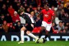 Manchester United's Paul Pogba, right, and Newcastle United's Florian Lejeune battle for the ball during their English Premier League soccer match at Old Trafford, Manchester, England, Thursday, Dec. 26, 2019. (Martin Rickett/PA via AP)