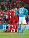 Liverpool's Fabinho lies injured before leaving the game during the Champions League Group E soccer match between Liverpool and Napoli at Anfield stadium in Liverpool, England, Wednesday, Nov. 27, 2019. (AP Photo/Jon Super)