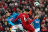Napoli's Fernando Llorente, left, competes for the ball with Liverpool's Virgil van Dijk during the Champions League Group E soccer match between Liverpool and Napoli at Anfield stadium in Liverpool, England, Wednesday, Nov. 27, 2019. (AP Photo/Jon Super)
