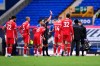 Referee Michael Oliver shows a red card to Everton's Richarlison, obscured at right, during the English Premier League soccer match between Everton and Liverpool at Goodison Park stadium, in Liverpool, England, Saturday, Oct. 17, 2020. (Laurence Griffiths/Pool via AP)