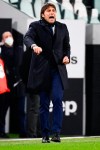 Inter coach Antonio Conte directs his team during the Italian Cup, return-leg, semifinal soccer match between Juventus and Inter Milan, at the Turin Allianz Stadium, Italy, Tuesday, Feb. 9, 2021. (Marco Alpozzi/LaPresse via AP)