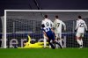 Juventus goalkeeper Wojciech Szczesny, left, can't stop a goal by Porto's Porto's Sergio Oliveira (27) during the Champions League, round of 16, second leg, soccer match between Juventus and Porto in Turin, Italy, Tuesday, March 9, 2021. (Fabio Ferrari/LaPresse via AP)
