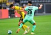 Dortmund's Giovanni Reyna, left, and Monchengladbach's Ramy Bensebaini fight for the ball during the Bundesliga soccer match between Borussia Dortmund and Borussia Monchengladbach at Signal Iduna Park, Dortmund, Germany, Saturday Sept. 19, 2020. (Bernd Thissen/Pool via AP)
