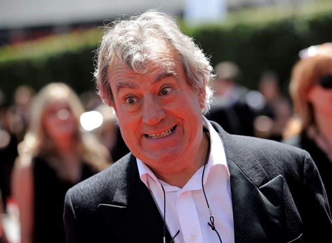 FILE - In this Saturday, Aug. 21, 2010 file photo, Terry Jones arrives at the Creative Arts Emmy Awards in Los Angeles. Terry Jones, a member of the Monty Python comedy troupe, has died at 77. Jones's agent says he died Tuesday Jan. 21, 2020. In a statement, his family said he died “after a long, extremely brave but always good humored battle with a rare form of dementia, FTD.” (AP Photo/Chris Pizzello, file)
