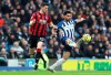 Bournemouth's Chris Mepham, left, and Brighton & Hove Albion's Alireza Jahanbakhsh battle for the ball during the English Premier League soccer match at the AMEX Stadium, Brighton, England, Saturday Dec. 28, 2019. (Gareth Fuller/PA via AP)
