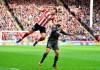 Sheffield United's George Baldock, left, and Norwich City's Emi Buendia battle for the ball during the English Premier League soccer match at Bramall Lane, Sheffield, England, Saturday March 7, 2020. (Anthony Devlin/PA via AP)