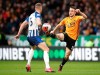 Brighton and Hove Albion's Adam Webster, left, and Wolverhampton Wanderers' Diogo Jota battle for the ball during the English Premier League soccer match between the Wolverhampton Wanderers and Brighton and Hove Albion, at Molineux, in Wolverhampton, England, Saturday March 7, 2020. (Nick Potts/PA via AP)