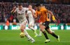 Sheffield United's Jack O'Connell, left, and Wolverhampton Wanderers's Raul Jimenez battle for the ball during the English Premier League soccer match at Molineux, Wolverhampton, England, Sunday Dec. 1, 2019. (Bradley Collyer/PA via AP)