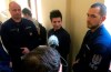 FILE - In this Tuesday, March 5, 2019 file photo, Portuguese Rui Pinto, center, is surrounded by police officers in the hallway of the Metropolitan Court in Budapest, Hungary, as he awaits a decision on his extradition to Portugal. Pinto denies wrongdoing. A Portuguese judge ruled Friday Jan. 17, 2020, that prosecutors have enough evidence incriminating Rui Pinto, an alleged hacker charged with publishing internal documents, to stand trial. (AP Photo/Pablo Gorondi, File)